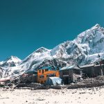 Orange and Gray Houses Near Snow Covered Mountain