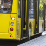 Modern Yellow City Bus with Open Doors at Bus Station