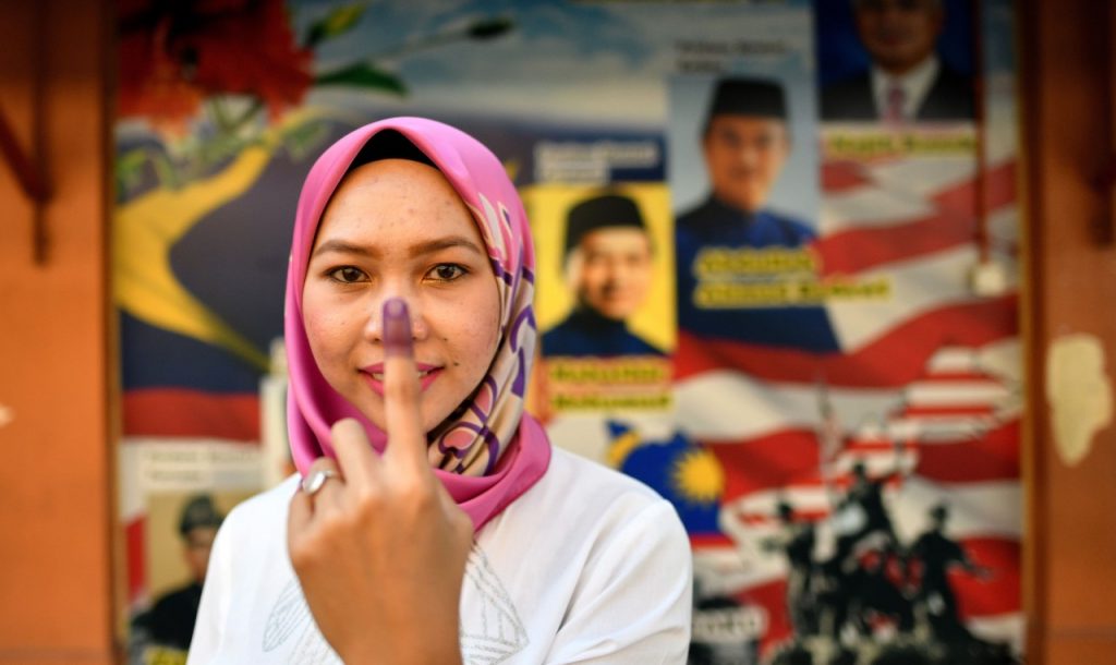 a Malaysian Voter Queueing to Vote in 2018 - Some Voters Believed They Were Making History. in a Way, They Did — Just Not the Kind They Expected.